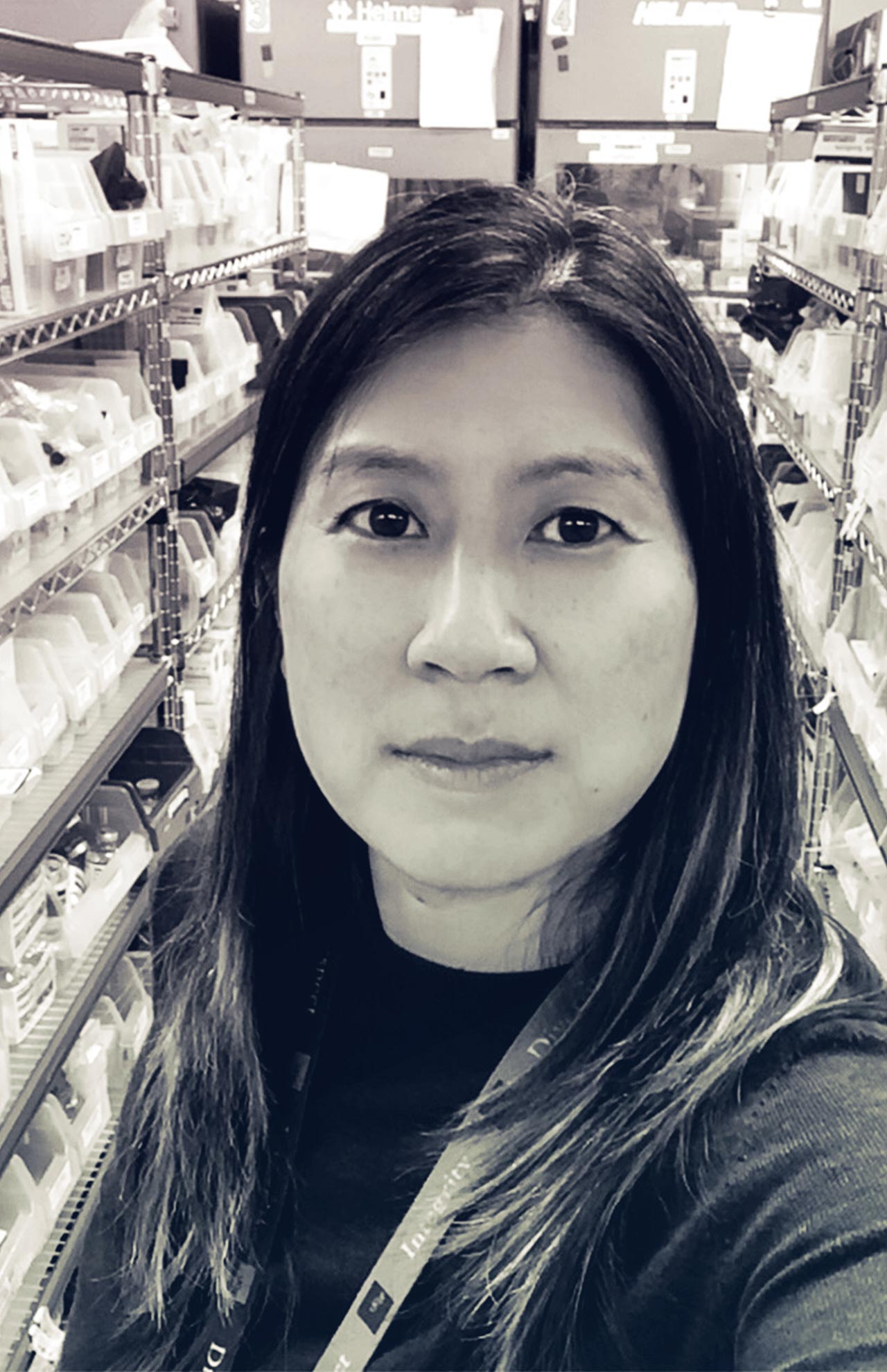Portrait of Katherine Yang with the pharmacy in the background.