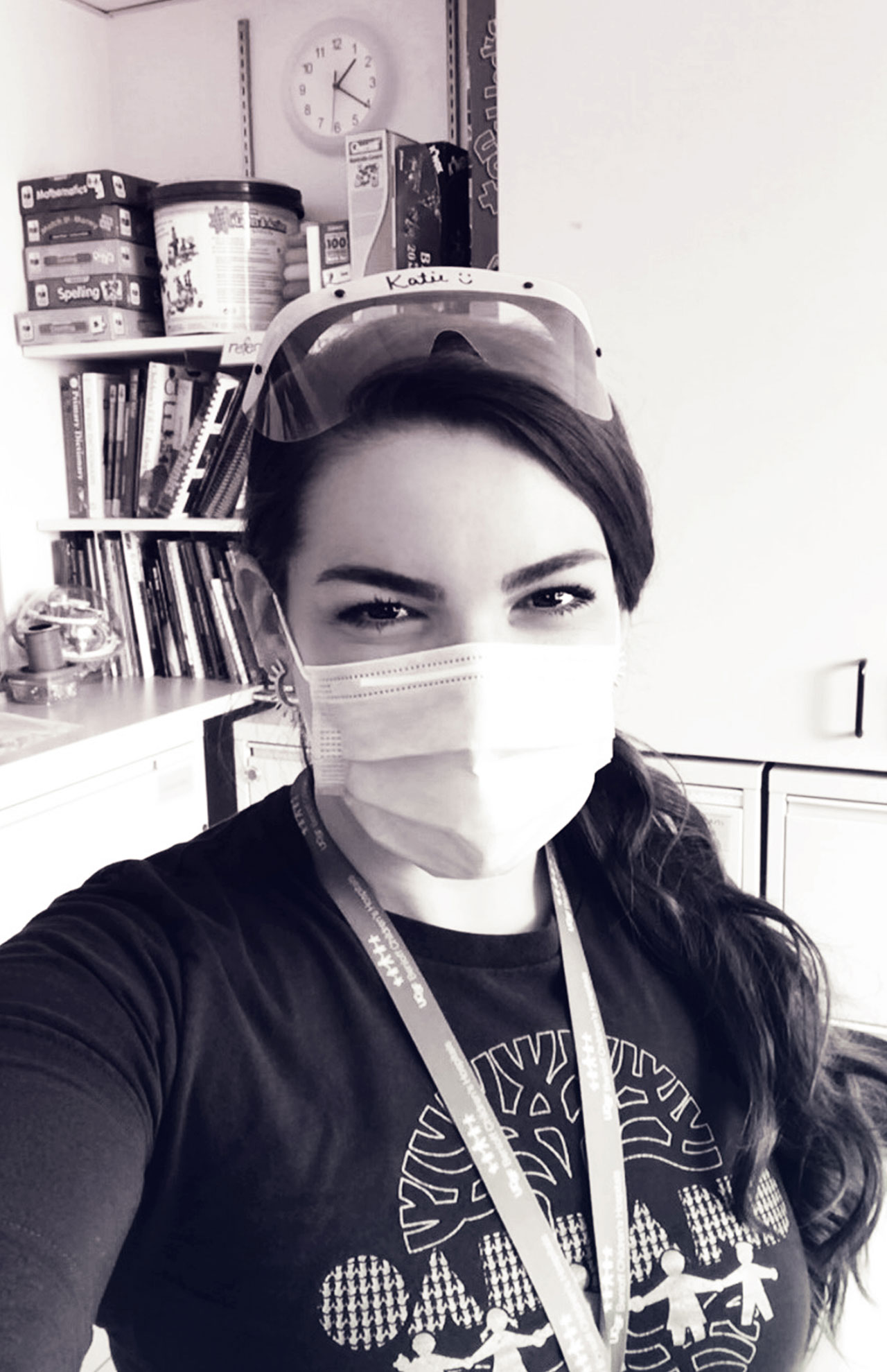 Portrait of Katie Craft with a face mask and protective eyewear on her head.