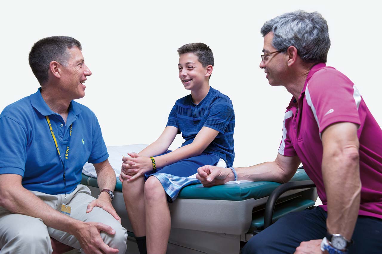 Gender Center director Stephen Rosenthal (left) visits with Shay and his father, Wayne.