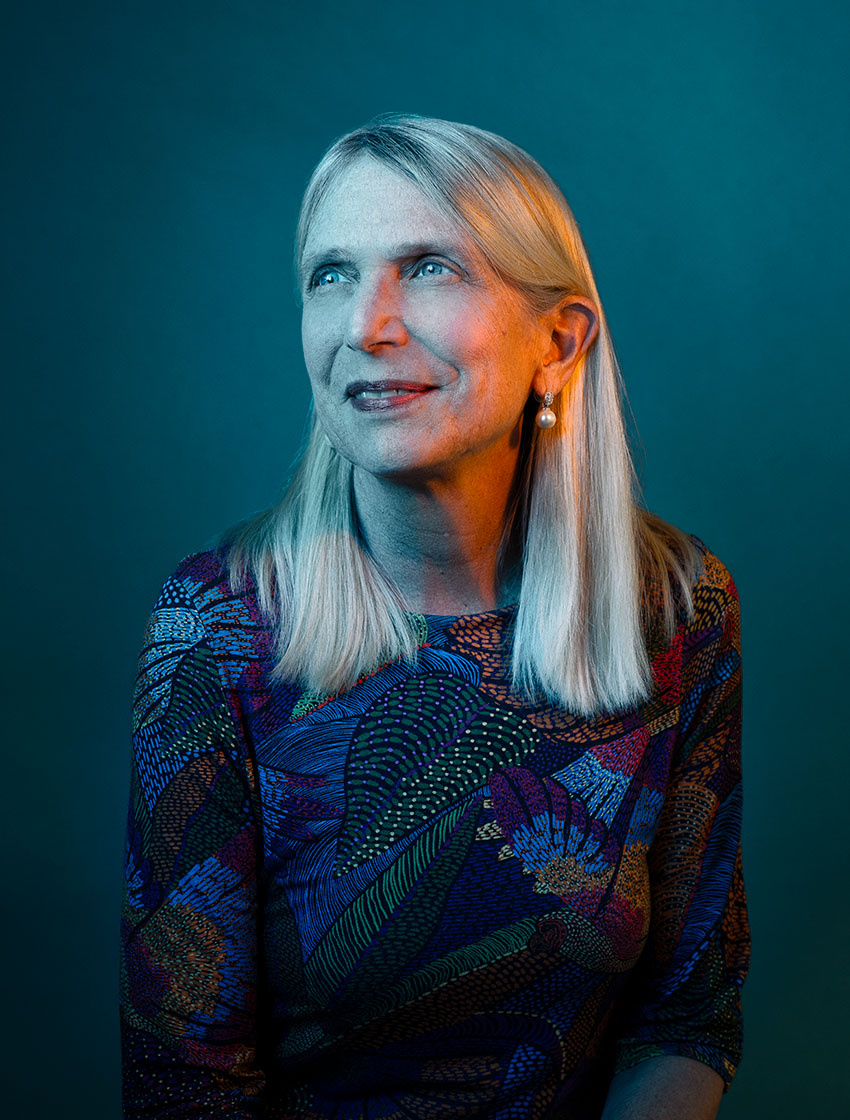 Artistic photo of Diane Havlir with dark blue and pink lighting