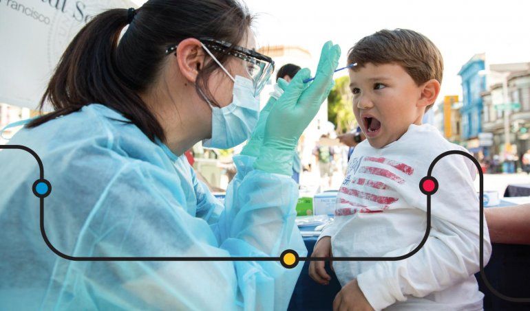 A dental student examines a toddler at a mobile dental clinic.