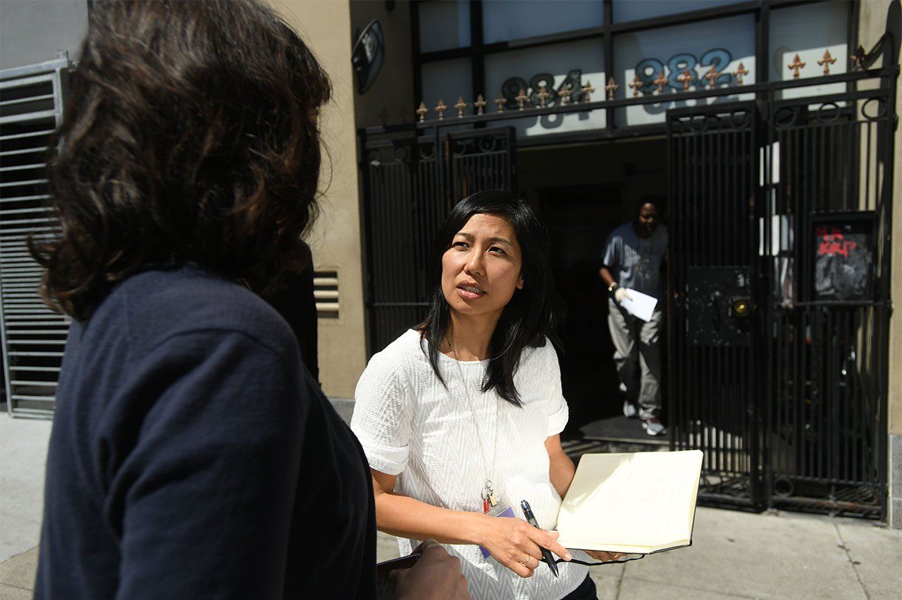 Photo of Fumi Mitsuishi speaking to Carrie Cunningham outside.