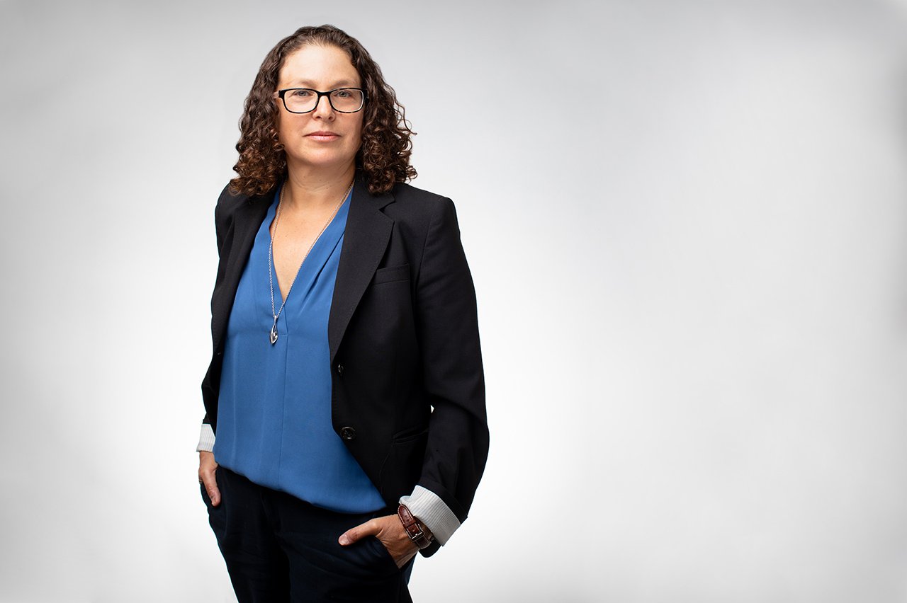 Portrait of Margot Kushel in front of a white backdrop.