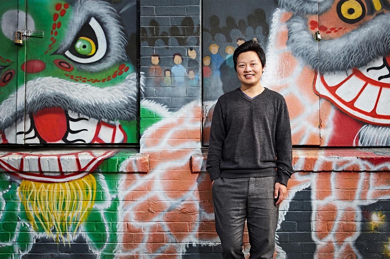 Photo of Richard Feng, MD, in front of a mural of painted dragons, in Chinatown, San Francisco.