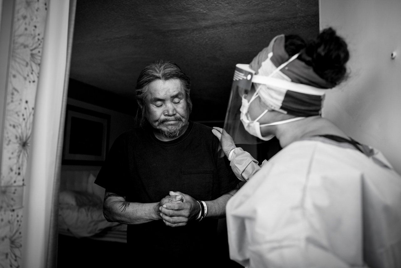 doctor talks with man in a hotel doorway