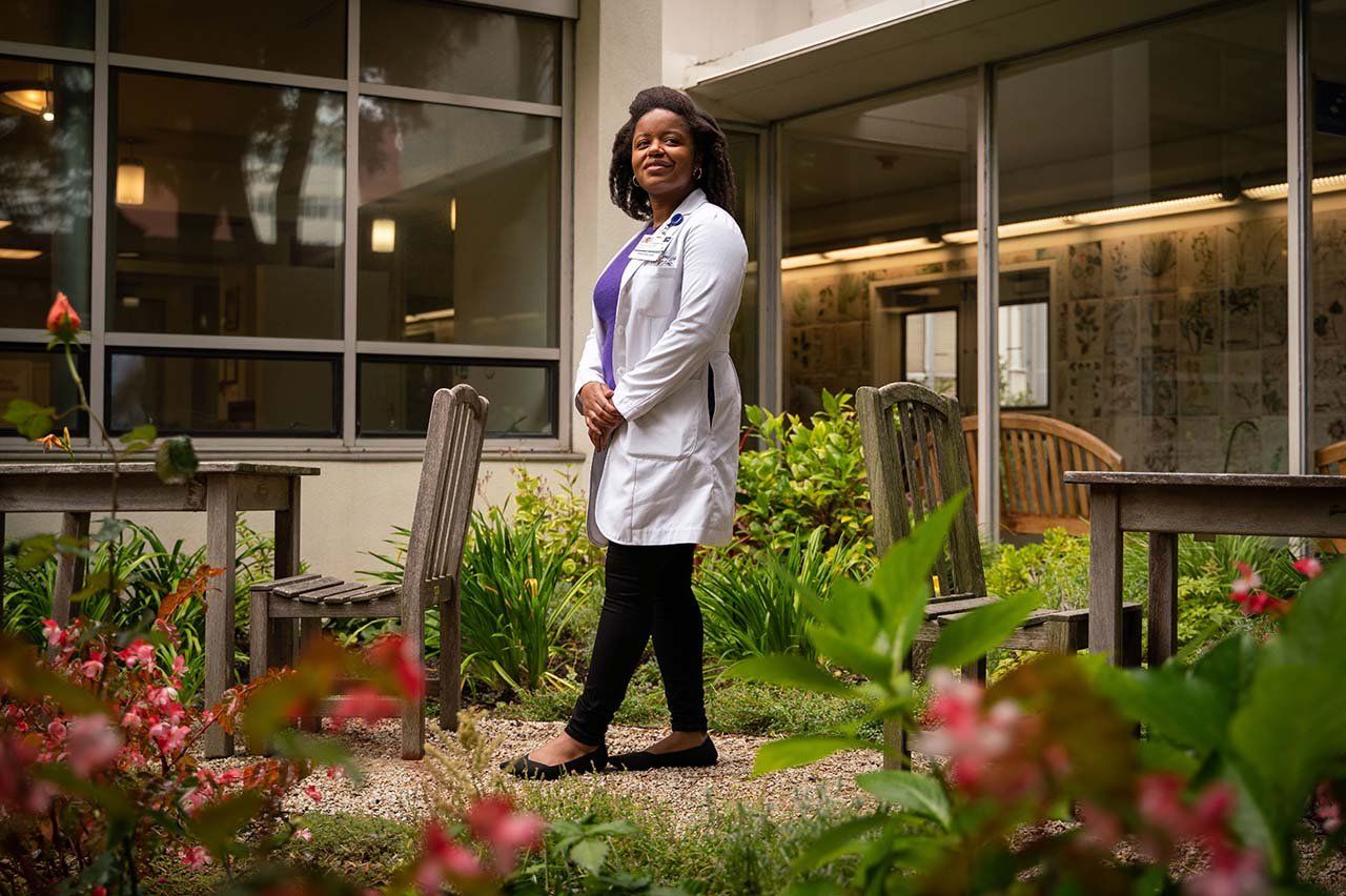 Jenna Lester stands in a garden outside a UCSF clinic