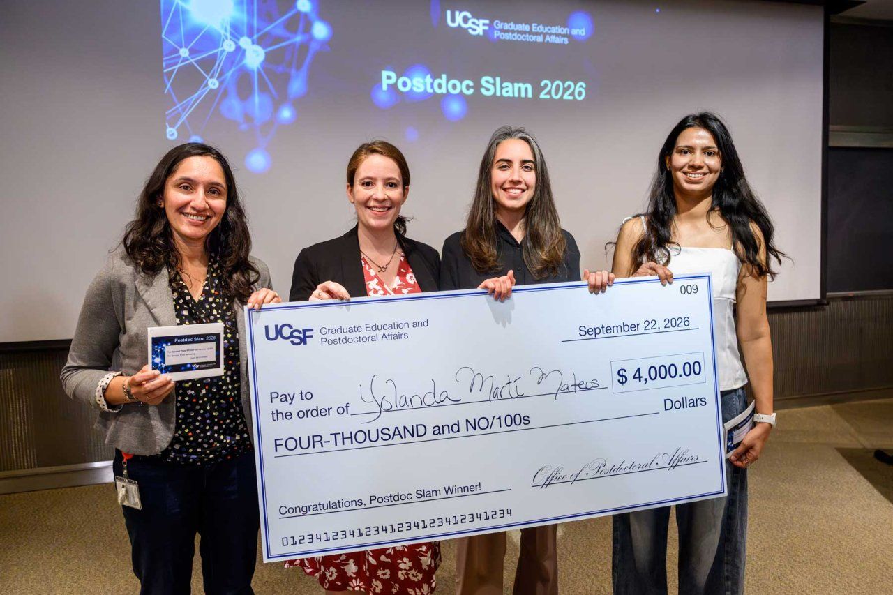 The first, second, and third place winners, along with the People's Choice Award winner, hold t