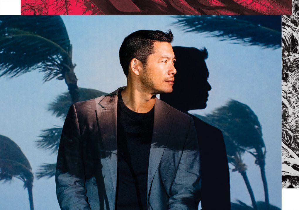 Portrait of Dr. Peter Chin-Hong in a photo studio setting with a projection of a hurricane with palm trees blowing in the wind.