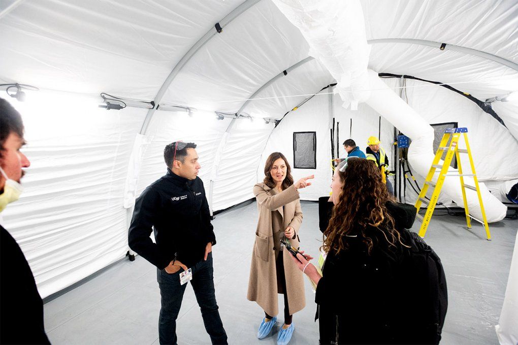 Maria Raven instructs staff inside a COVID-19 tent.