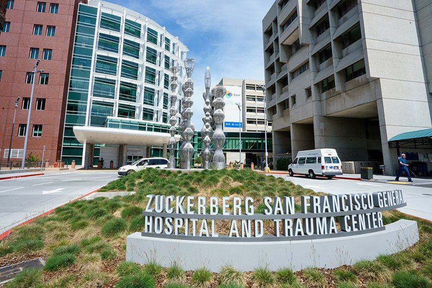 Photo of the Zuckerberg San Francisco General Hospital sign in front of the hospital buildings.
