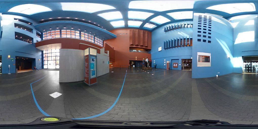 The lobby of the Rutter Center showing skylights far overhead and geometrical blue and orange walls