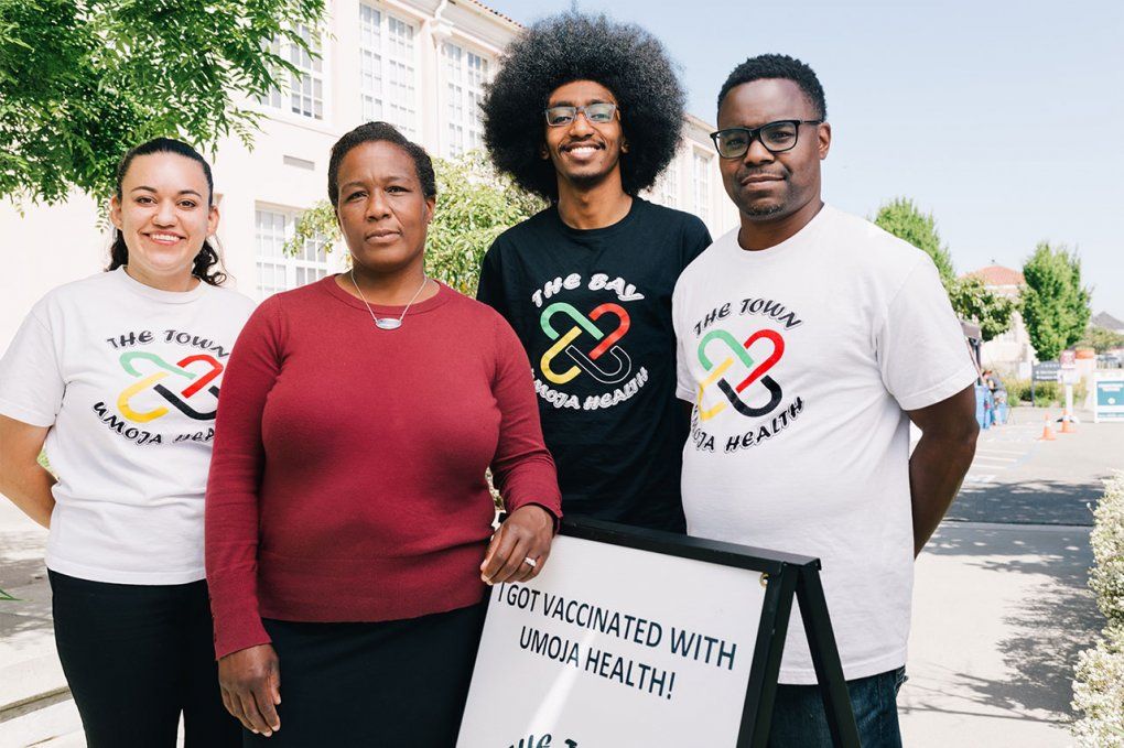 Photo of Kim Rhoads with staff members of Umoja Health Partners at a vaccine clinic.