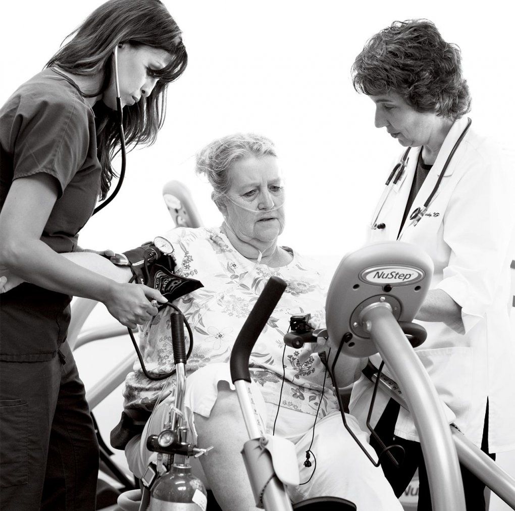 Nurse DorAnne Donesky and another nurse care for a patient.