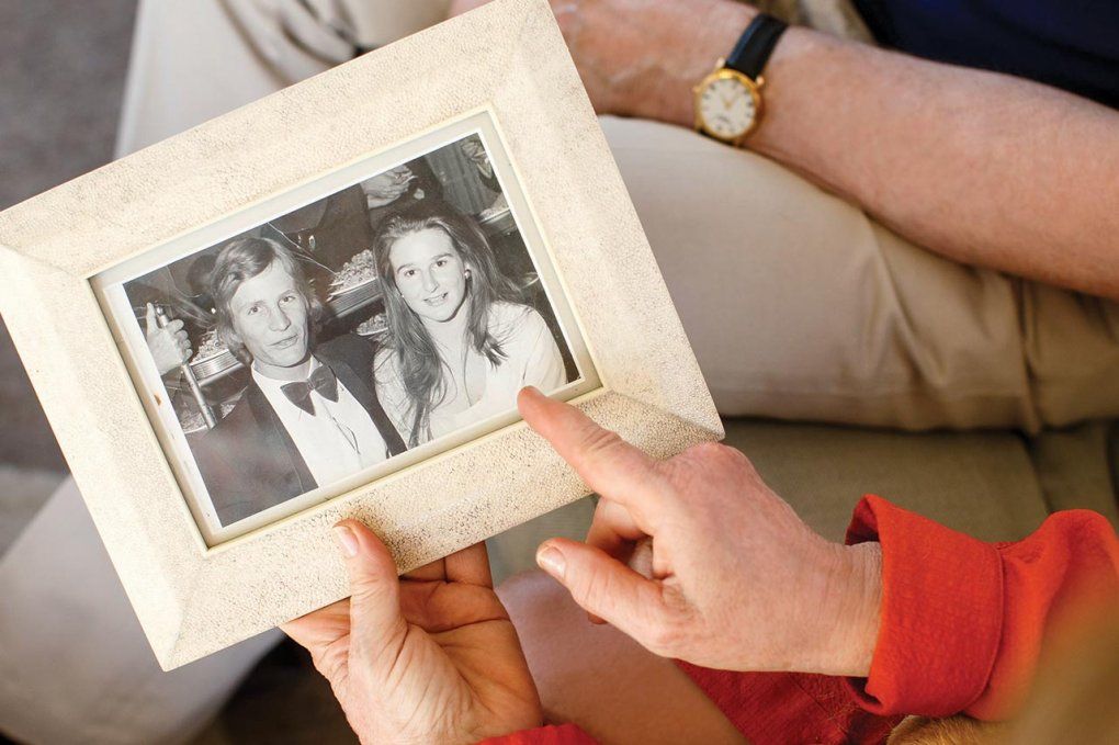 Sam and Jane Hawgood hold a framed picture of themselves when they were young.