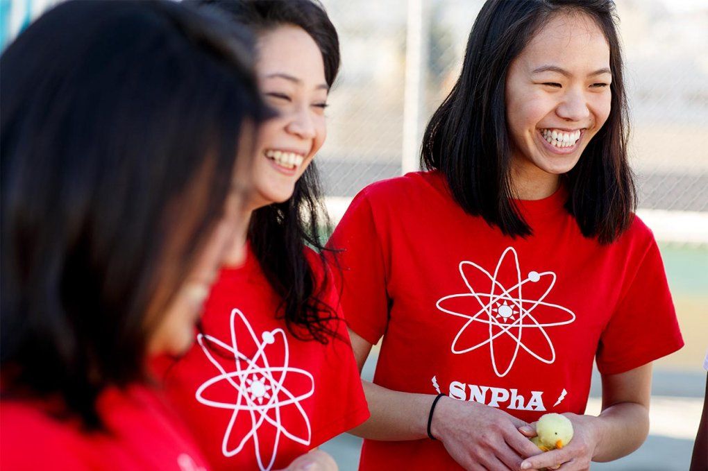 UCSF students in matching red shirts, laughing.