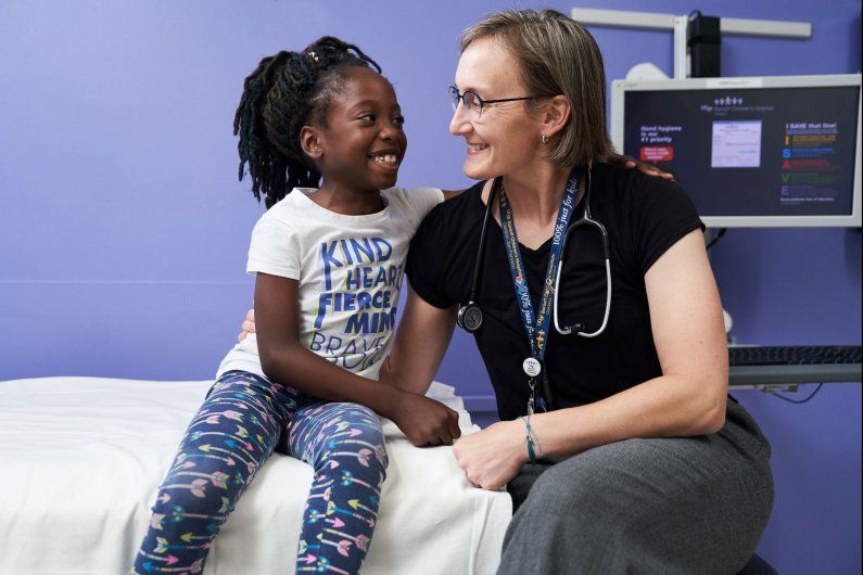 Doctor and patient smiling at each other. 