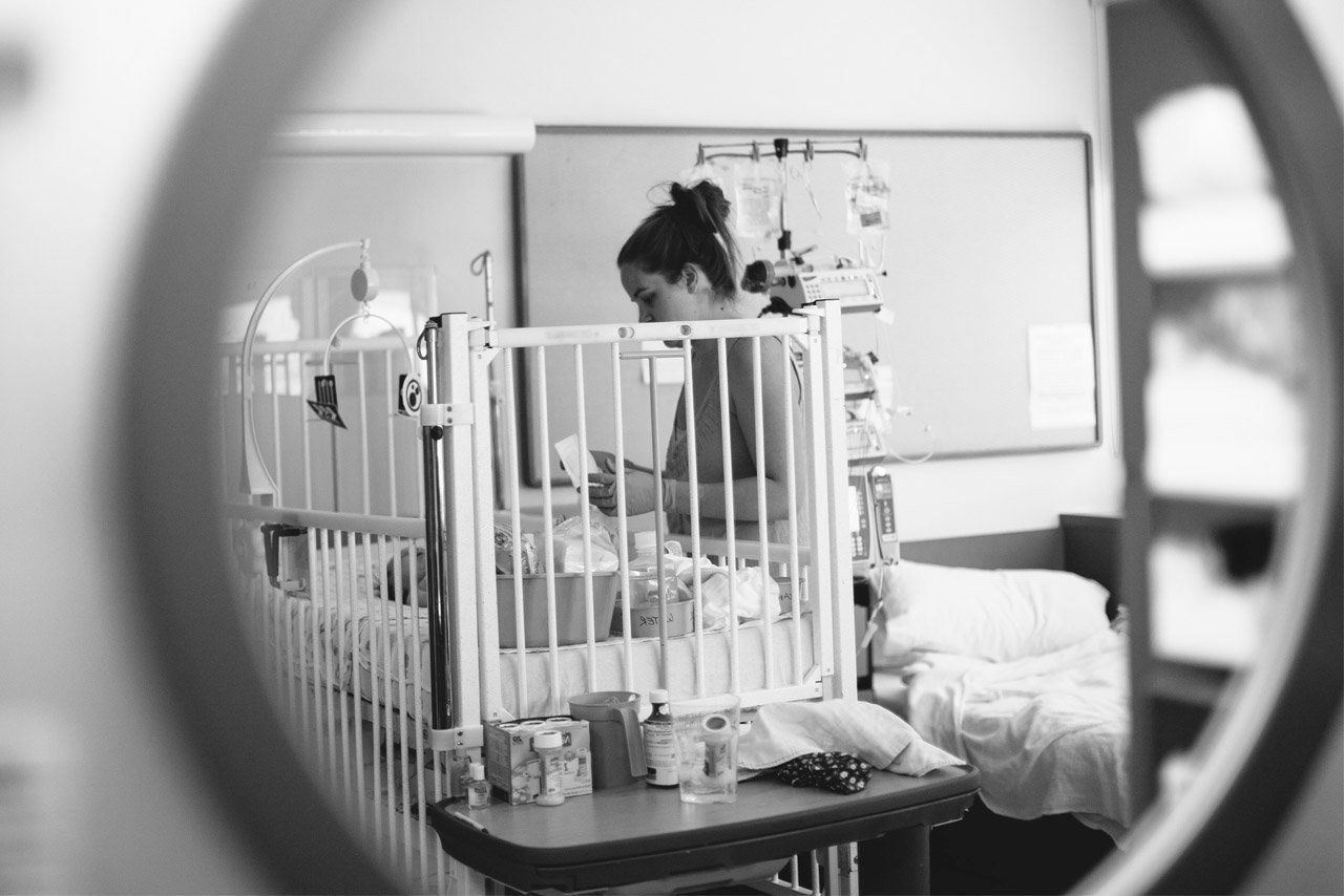 Mother Alissa cares for baby Riley in her hospital crib.