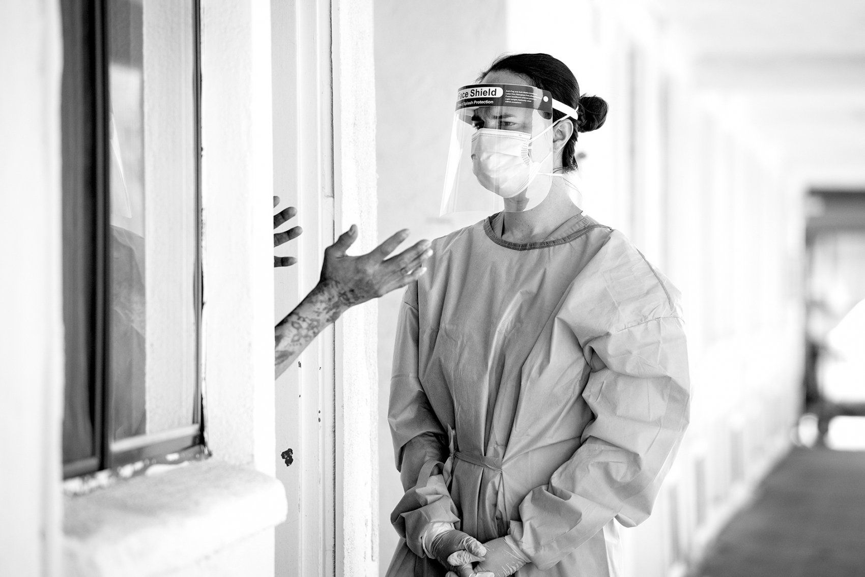 health worker talks with man in motel doorway