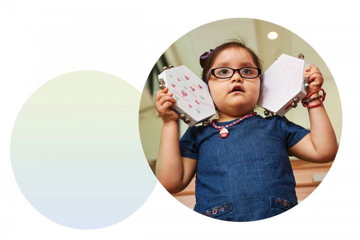 Photo of Joy Littlesunday holding tambourines.