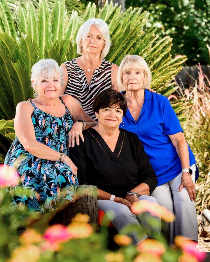Four women sitting in a garden.