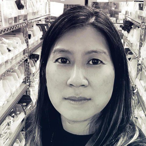 Portrait of Katherine Yang with the pharmacy in the background.