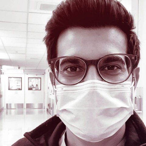 Portrait of Sajan Patel wearing a face mask in the hospital.