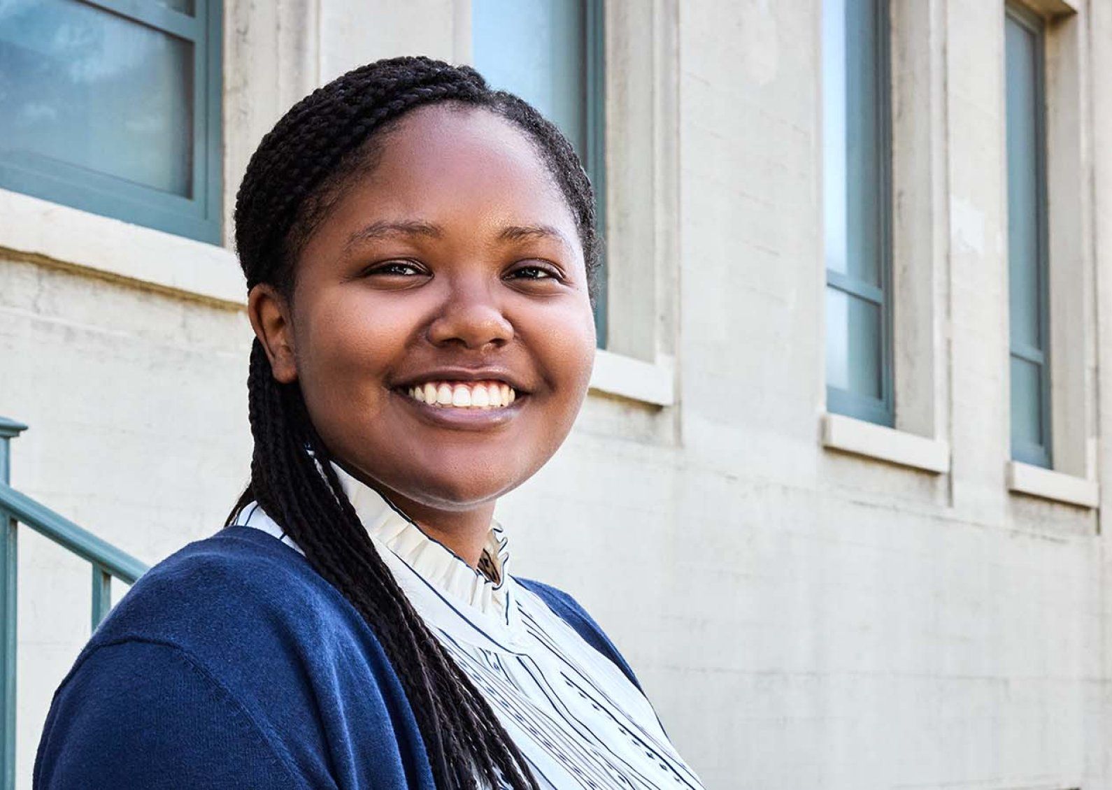 Olivia Waters smiles and stands outside the Clinical Sciences Building at UCSF’s Parnassus Heights campus.