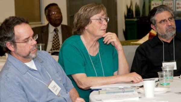 Corinne Woods sitting at a table at a Community Advisory Group meeting