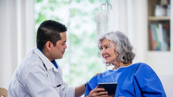 Doctor talking to patient, senior woman