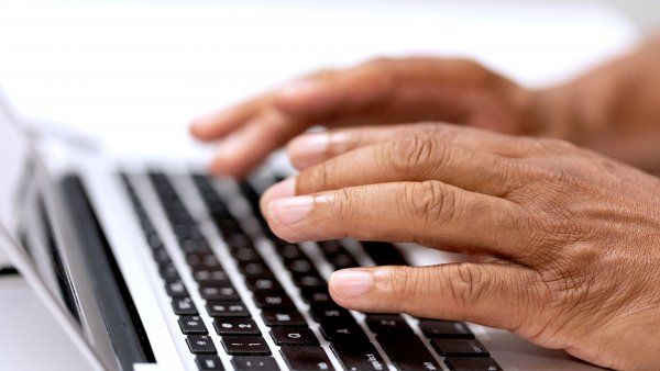 hands typing on laptop computer