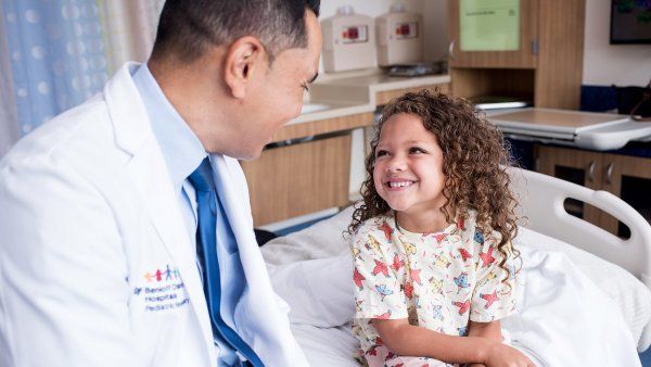 doctor talks with young patient