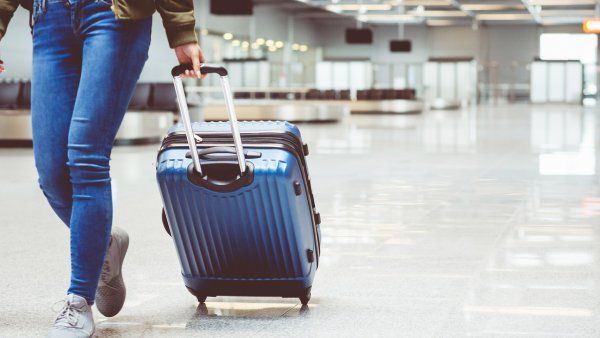 woman rolls a suitcase