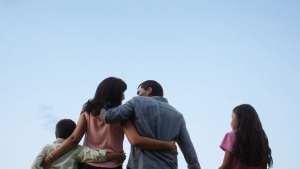 Family of four with sky in background