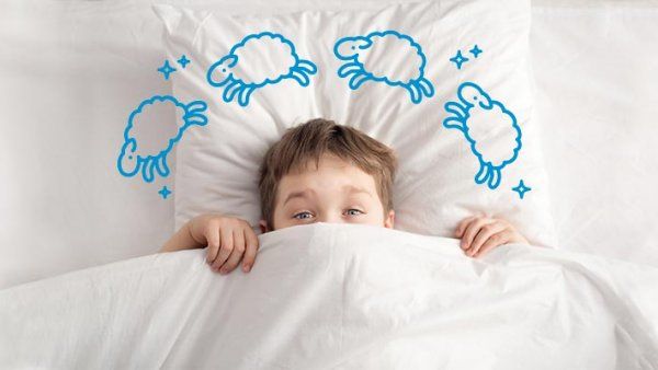 Photo of a child in a bed, peaking above the covers; illustration of sheep and stars circle around their head.