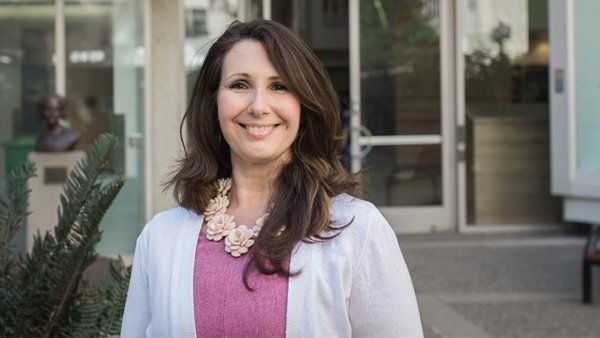 Photo of Gina Intinarelli outside the UCSF School of Nursing.