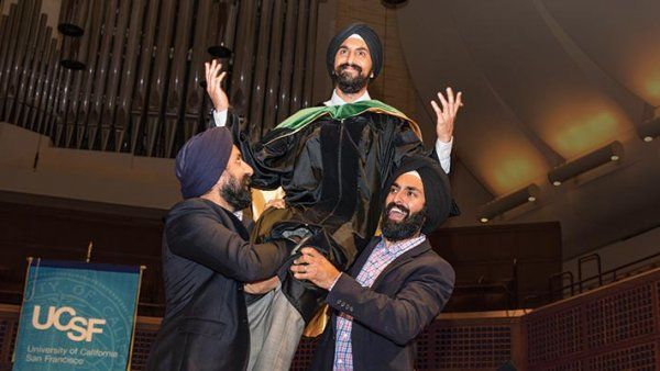 Paul and Ravi Gogia lift their younger brother Shawn onto their shoulders at his graduation ceremony.