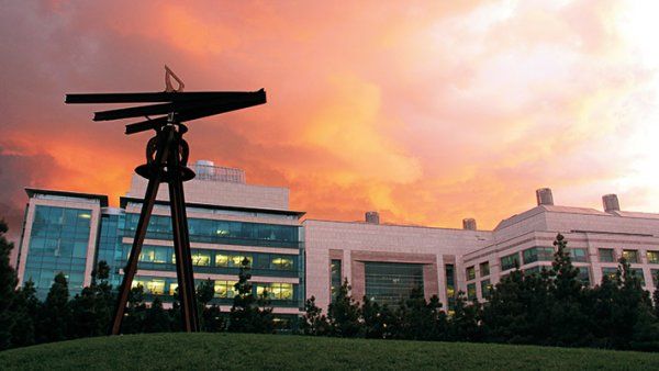 Photo of the "Dreamcatcher" large-scale, metal sculpture by artist Mark di Suvero, located in Koret Quad, UCSF Mission Bay Campus, at sunset.