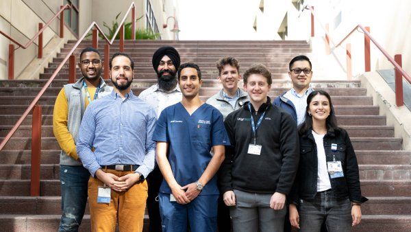 Eight First Gen Scholarship recipients pose for a photo on stairs at Parnassus campus