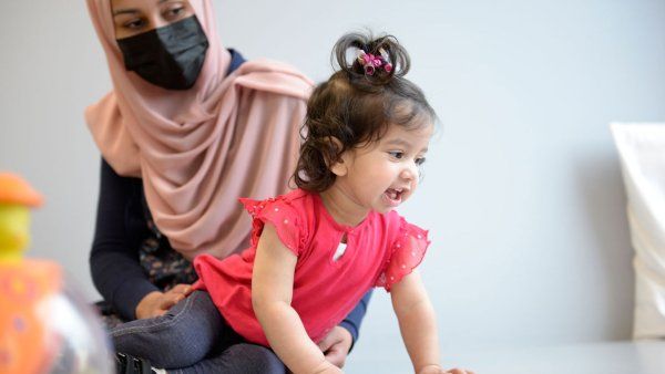 Sobia Qureshi watches her daughter Ayla smile and crawl