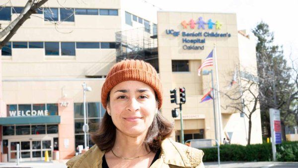 Artist Adia Millett stands in front of the entrance to Benioff Children's Hospital, Oakland.