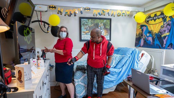 Clarissa Kripke checks in on her patient Russell Hughes in his home bedroom, where there's a hospital bed along with personal Spider Man-themed decorations