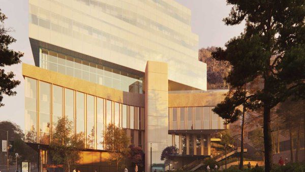 A rendered conceptual image of the outside facade of the UCSF Bakar Research and Academic Building at sunset, which has modern glass and concrete features.