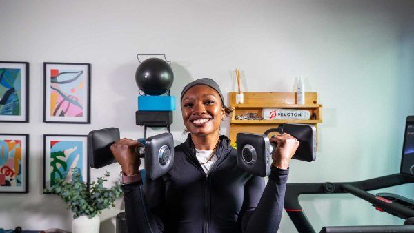 Neurologist Lauren Patrick smiles as she lifts weight at her home gym.