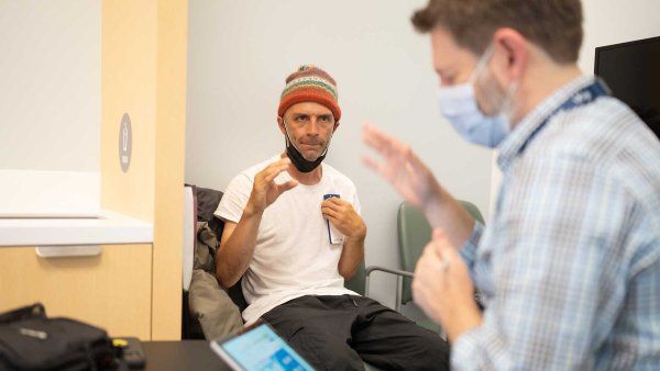 Skateboarder and Parkinson's patient Shawn Connolly practices some hand movements following the directions of Dr. Nicholas Galifianakis to test a deep brain stimulation treatment.