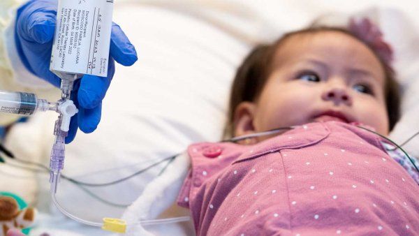 A baby girl named Luciana, who has Artemis-SCID, has medication pumped into her IV bag.