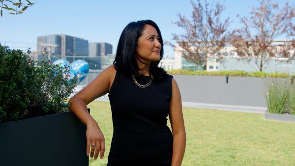 Side profile shot of DA Ailene Estalilla with San Francisco city skyline as the behind her
