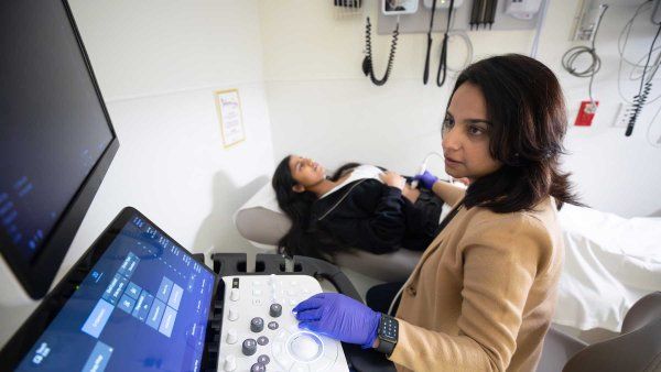 Dr. Sabina Ali performs an intestinal ultrasound on a female patient.