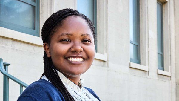 Olivia Waters smiles and stands outside the Clinical Sciences Building at UCSF’s Parnassus Heights campus.