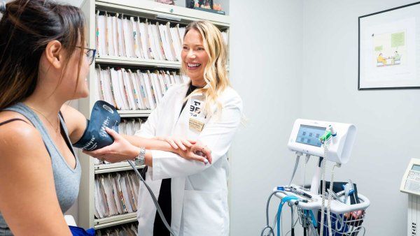 Nurse practitioner Melissa Fesler conducts an exam on a patient in an exam room.