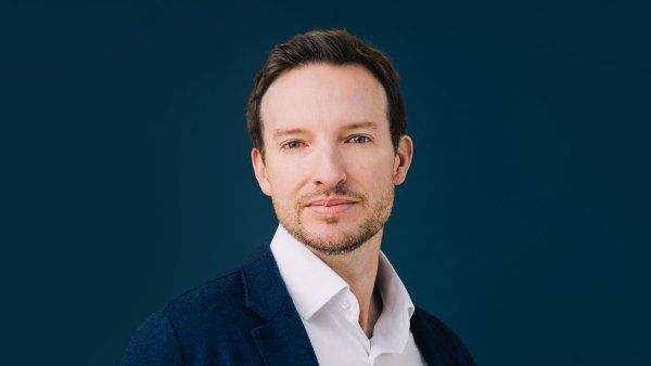 Kole Roybal stands in front of a dark blue background.